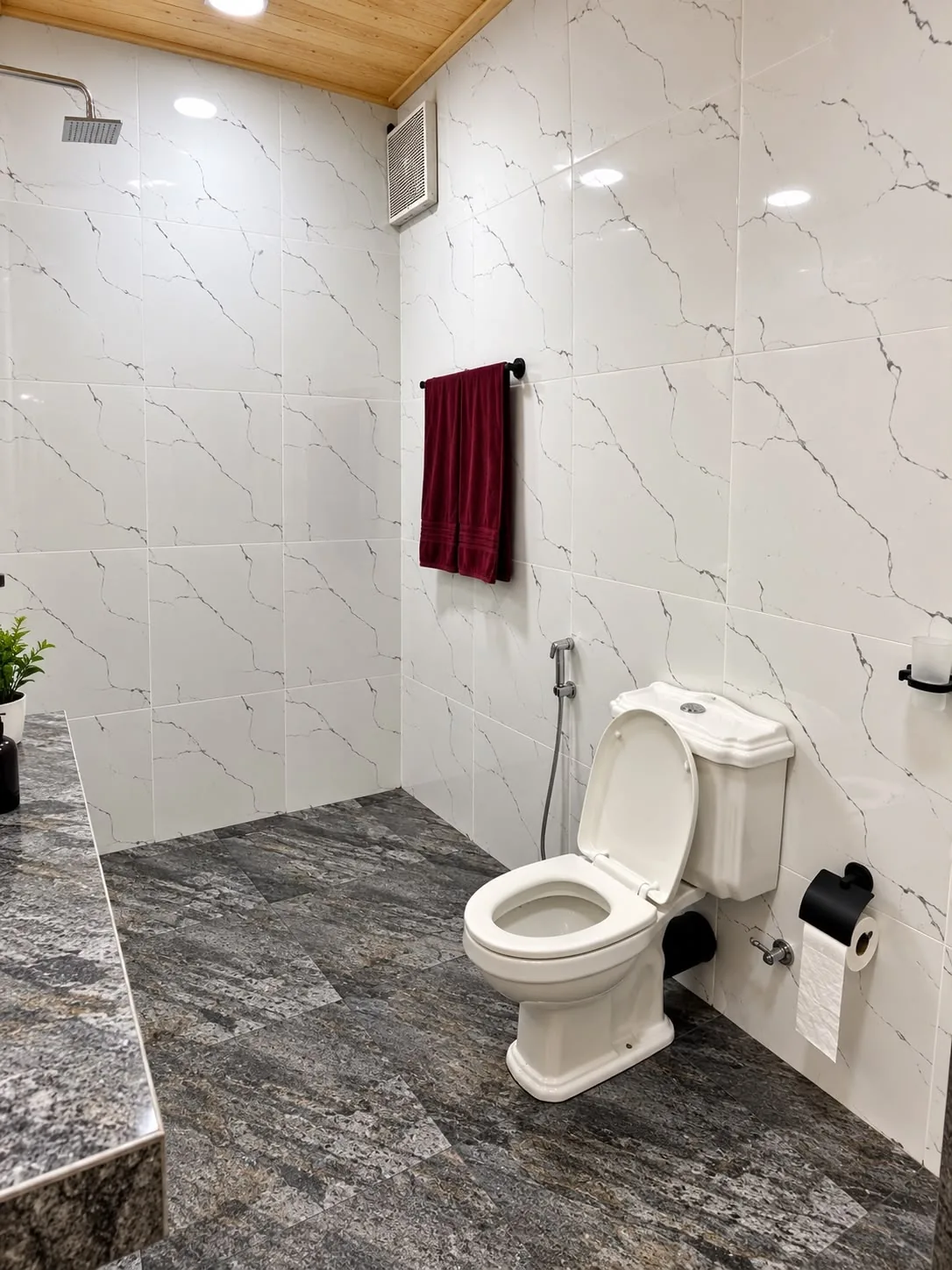 Bright bathroom with pale tiled walls and a shower area